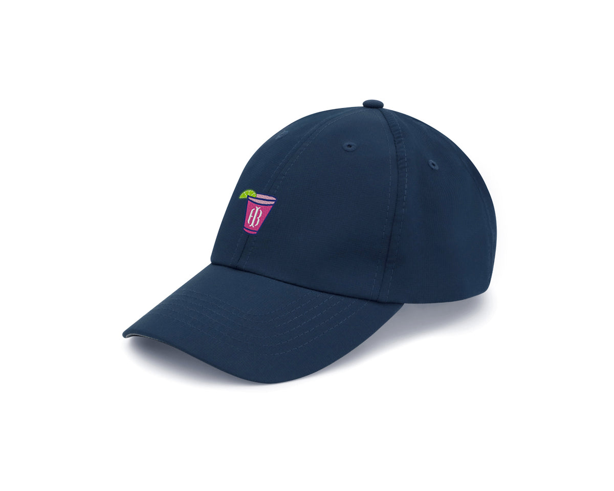 Navy transfusion hat with embroidered Holderness and Bourne pink cocktail logo angled to the left.