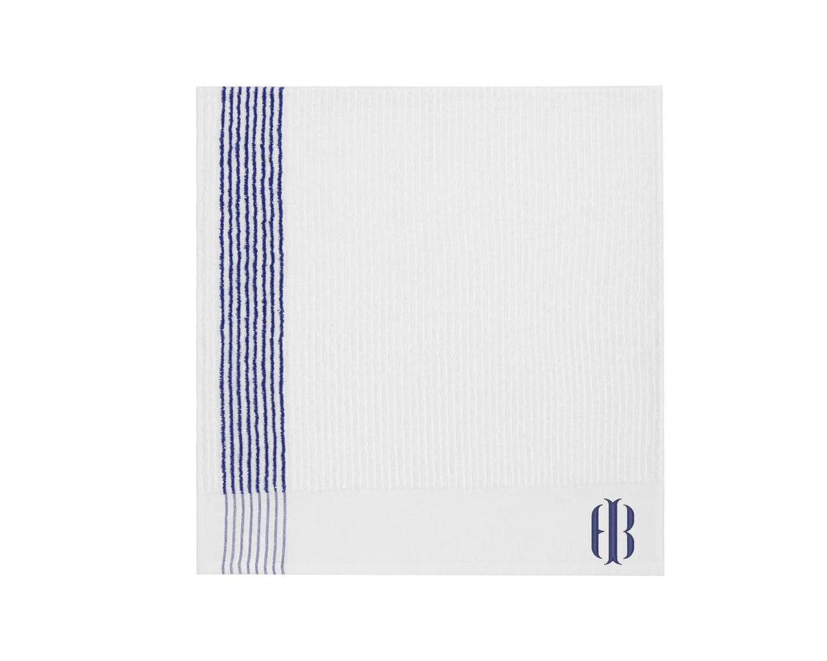 Square shaped white and blue striped Holderness and Bourne towel with logo embroidery.